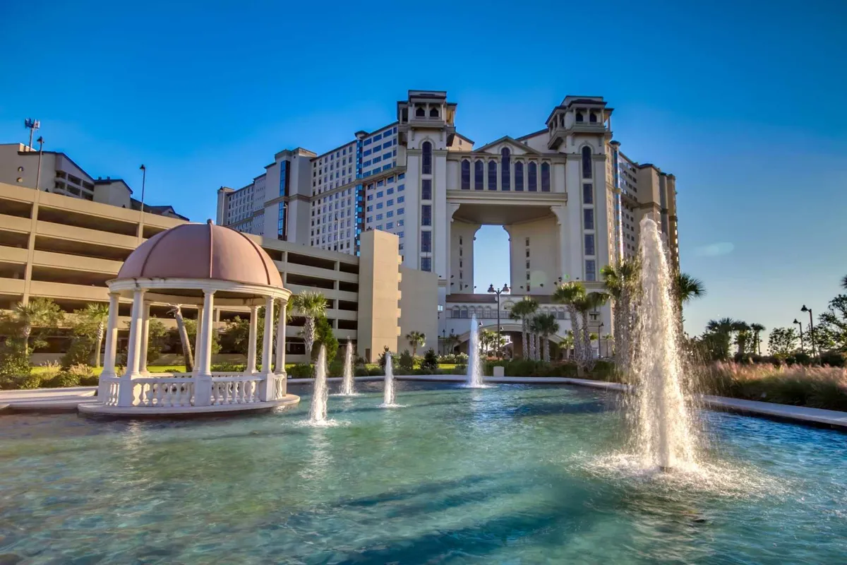 An elegant exterior view featuring serene fountains, a graceful gazebo, and striking resort architecture. The area is designed for peaceful strolls, quiet relaxation, and enjoying the beautifully landscaped grounds—ideal for winding down after an active day.